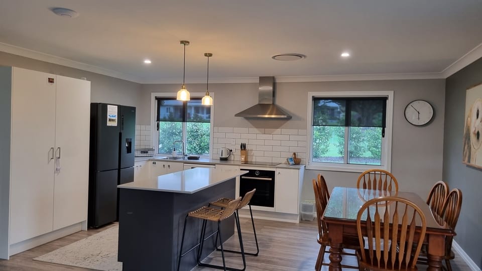 The kitchen/dining room with full size fridge, freezer, over, induction cooktop and microwave
