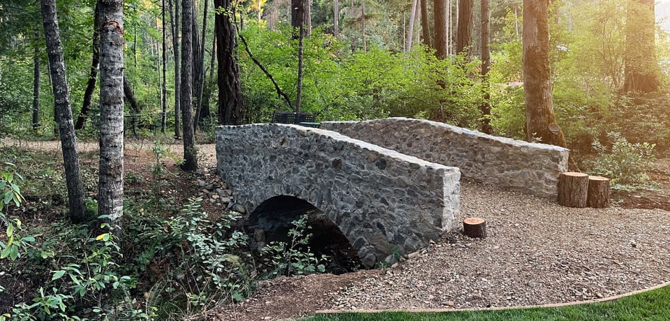 Stone bridge over creek leading to hiking trails. 