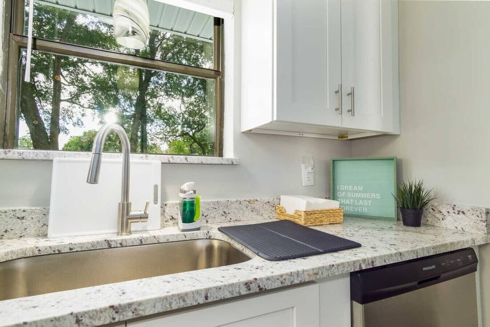 Enjoy a refreshing kitchen space with plenty of light, modern finishes, and a scenic view to inspire your cooking.