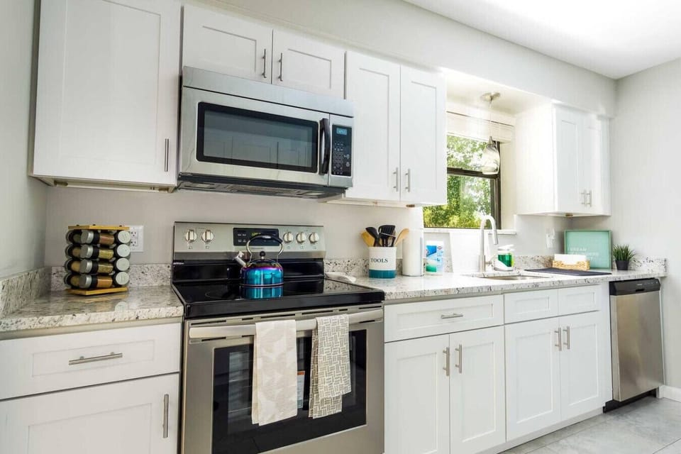 Stylish and functional kitchen with stainless steel appliances, perfect for cooking up your favorite meals.