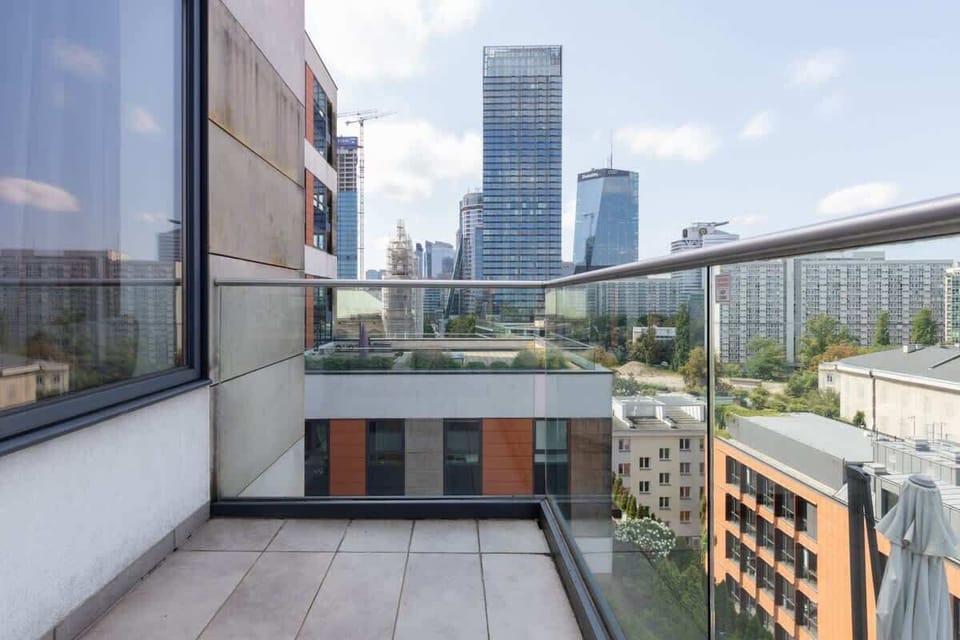 Spacious balcony with city view.