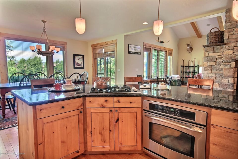 Fully stocked kitchen with gas cooktop and convection oven.
