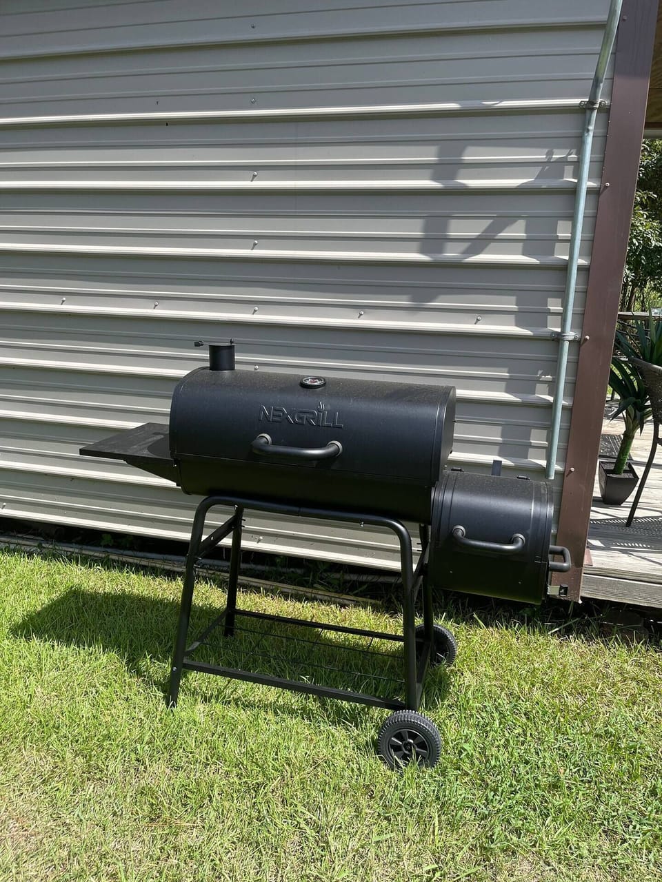 Charcoal grill with side pellet smoker.