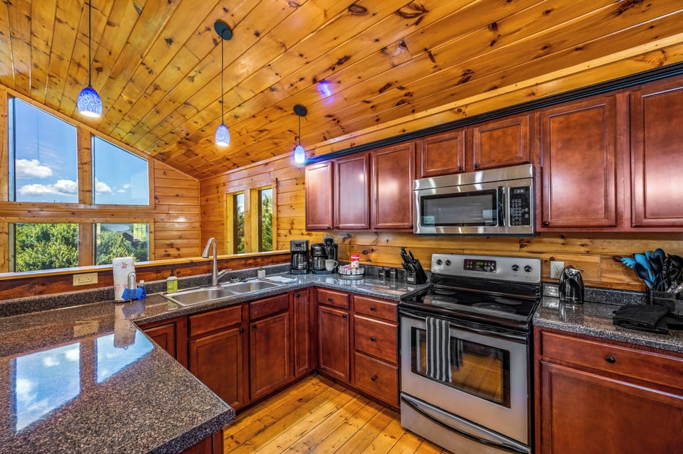 Fully Equipped Kitchen – Stainless steel appliances, wooden accents