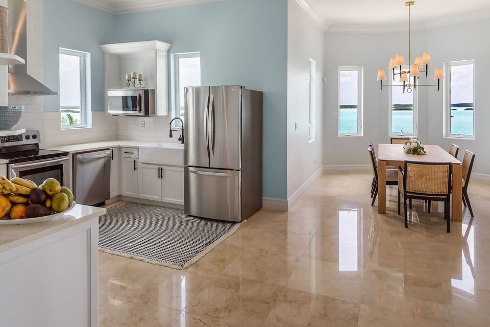 Main level fully equipped gourmet kitchen & dining with spectacular water views