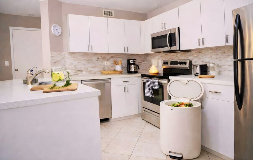 Modern kitchen with eco-conscious features Fully equipped space including a composter for biodegradable waste, designed for a more sustainable and mindful stay.