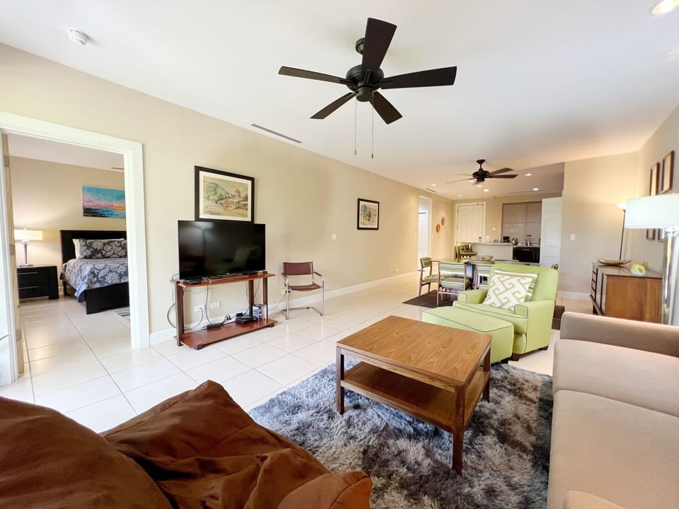 The bright living space features a 50" smart TV and comfortable furnishings. 