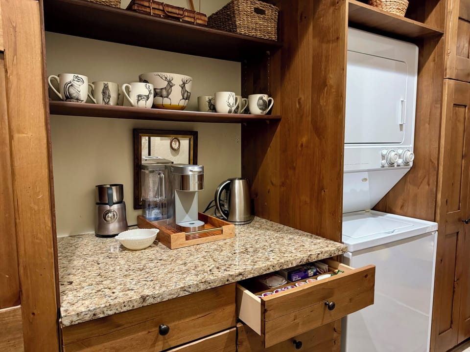 Coffee bar and laundry in main floor mud room. 