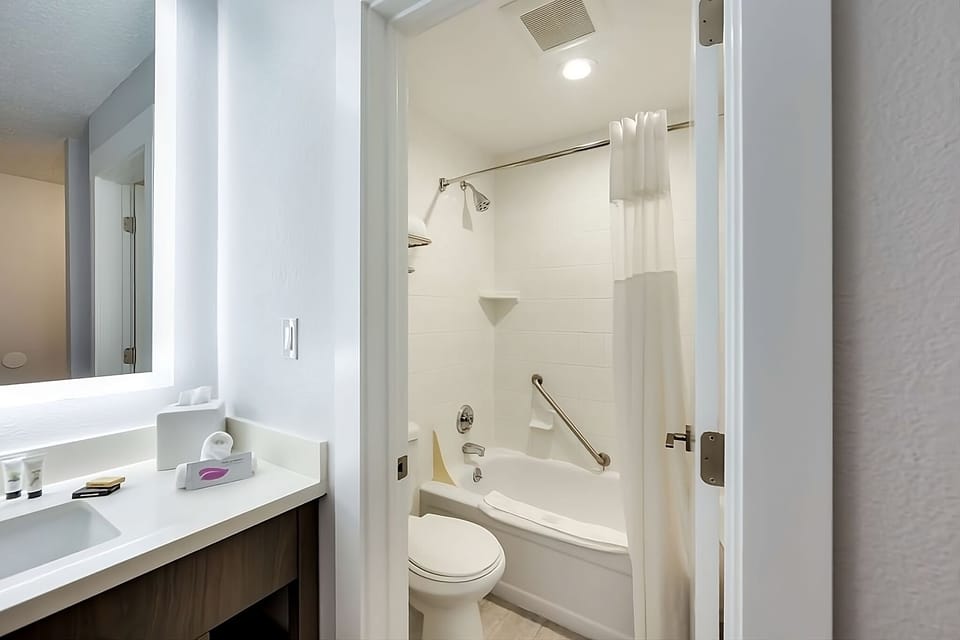 Bathroom with a shower and tub. The essential toiletries and towels are provided