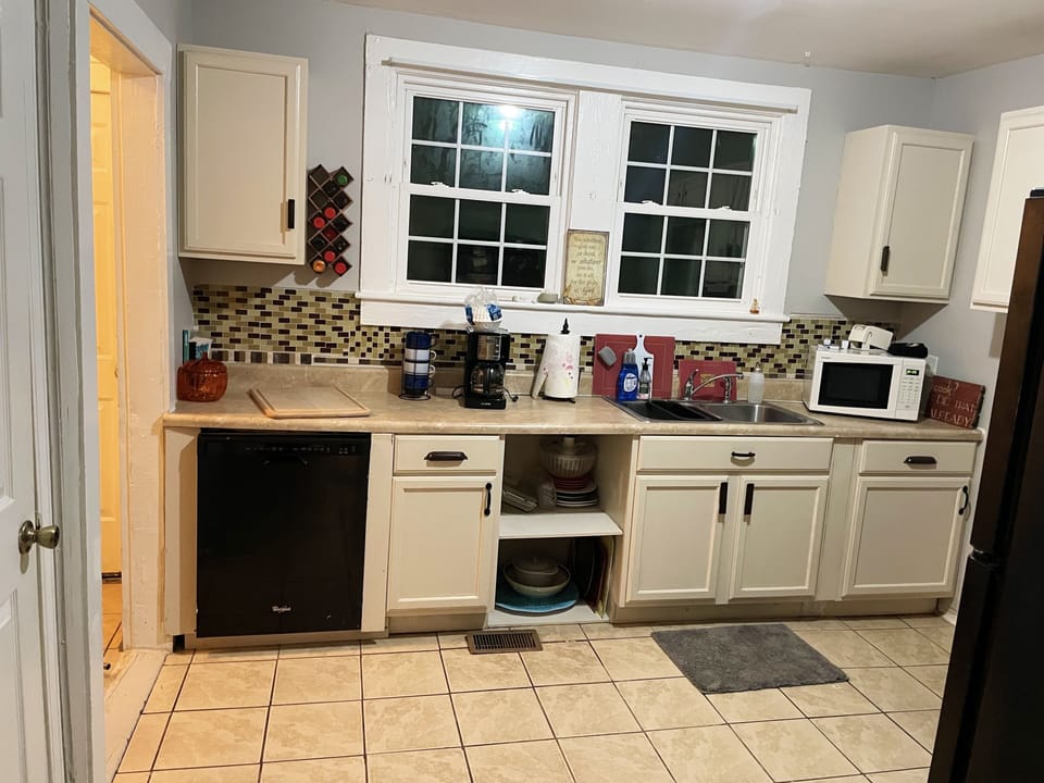 Kitchen with window overlooking wooded lot 