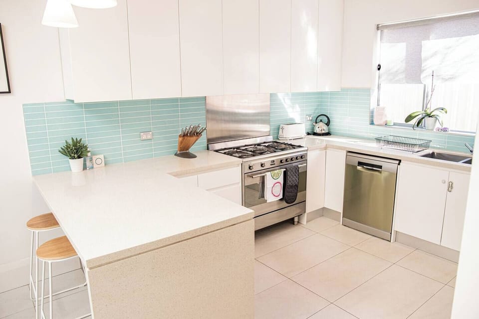 Modern kitchen layout with stainless steel appliances and ample prep space.