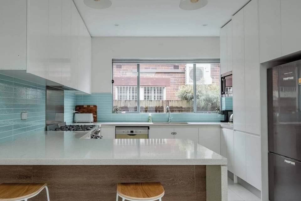 Bright and airy kitchen area with clean lines and a fresh coastal feel.