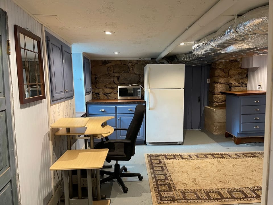 Additional room with desk, refrigerator, microwave, washer/dryer and storage