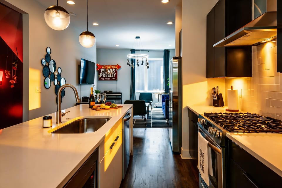 Kitchen island with a sink anchors the space, keeping prep and conversation flowing in the same room. Stove and oven handle whatever your group wants to cook