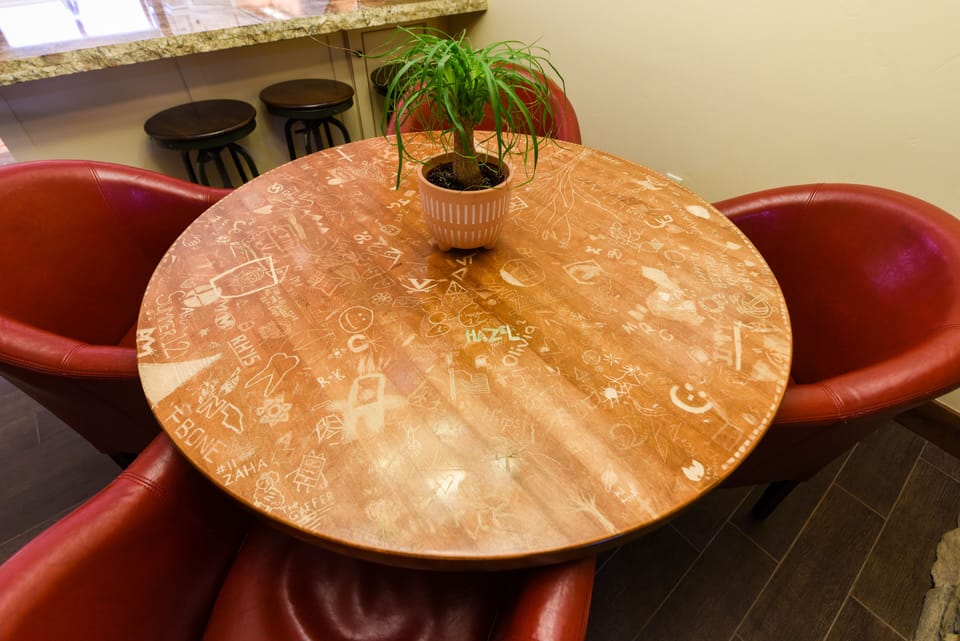 Dining Area - The table is beautifully engraved with all of the guests that have shared the experience of this Cedars home.