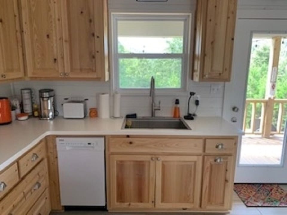 Brand new kitchen with a dishwasher.