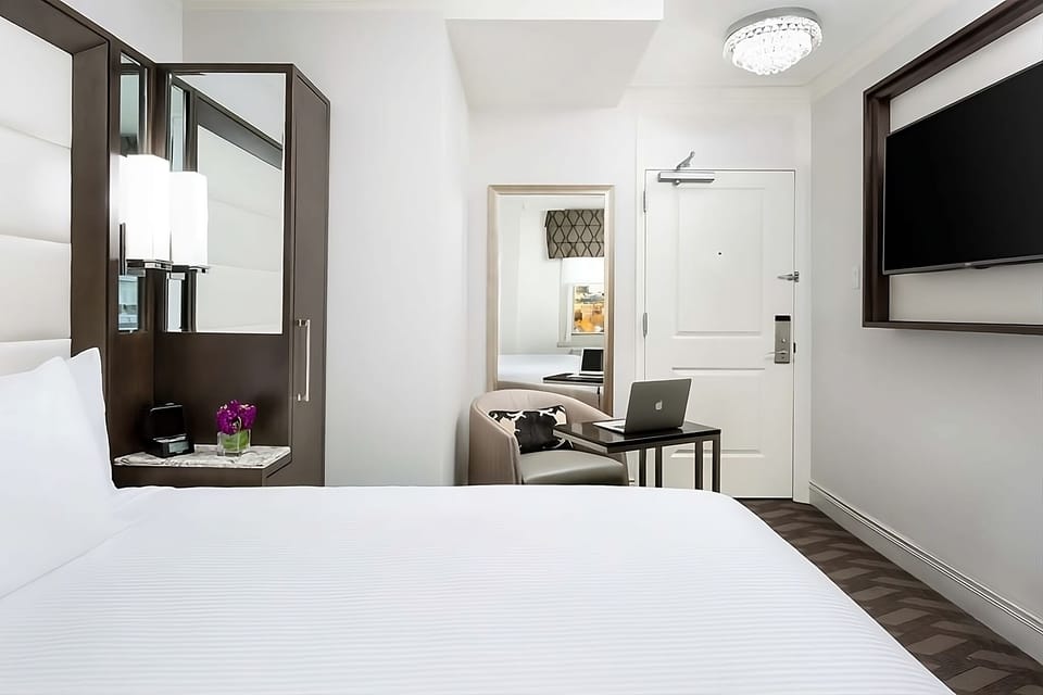 Unwind in a bright room with workspace and widescreen TV.