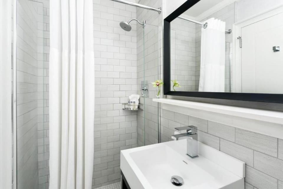 Refresh under a rain shower in a sparkling, tiled bathroom.