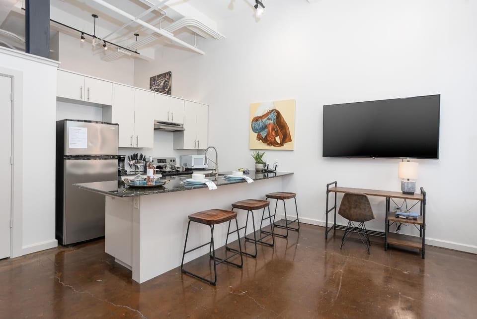 Cook and entertain in a sleek, fully-equipped kitchen featuring modern appliances, ample counter space, and all the essentials for a seamless dining experience in the heart of Fort Worth.