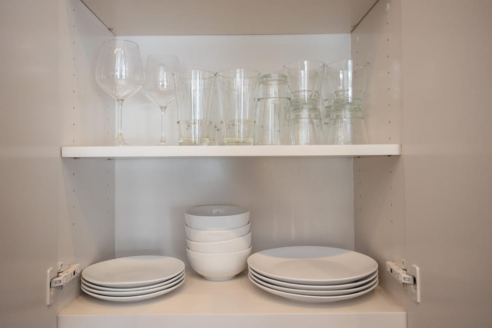 Cook and entertain in a sleek, fully-equipped kitchen featuring modern appliances, ample counter space, and all the essentials for a seamless dining experience in the heart of Fort Worth.