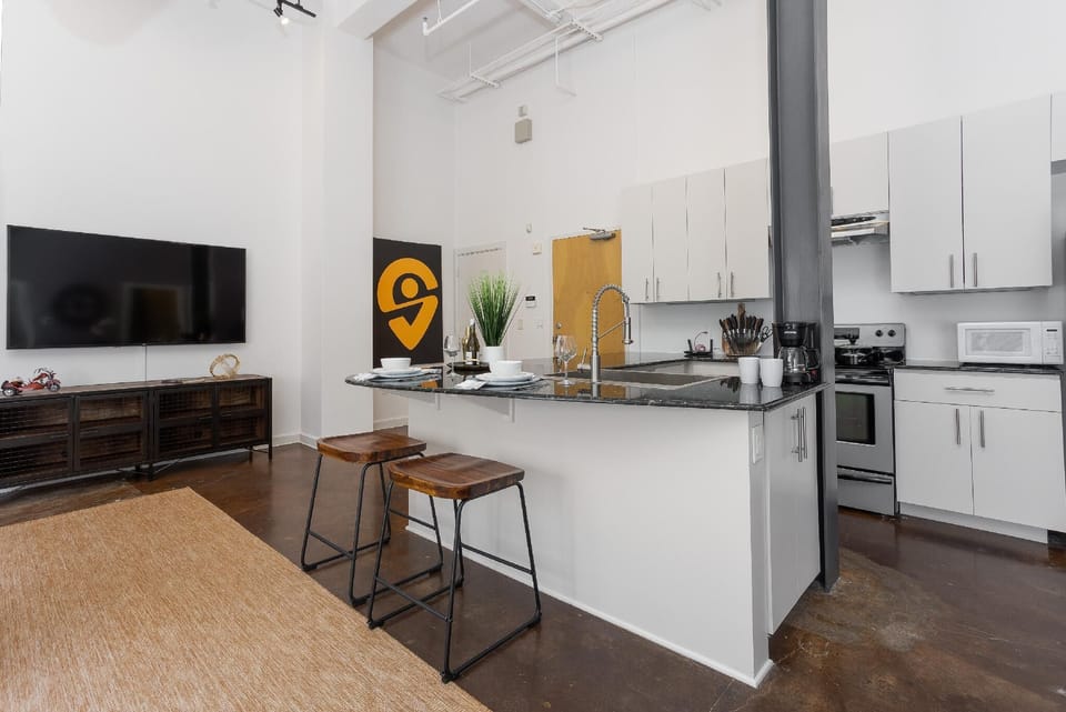 Cook and entertain in a sleek, fully-equipped kitchen featuring modern appliances, ample counter space, and all the essentials for a seamless dining experience in the heart of Fort Worth.