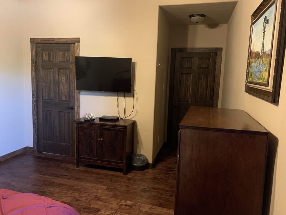 Red room with Smart TV - Its own sink, shares J&J Shower and toilet - downstairs