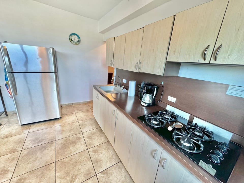 large open kitchen with island . Equipped pots,pans, blender, coffee machine etc