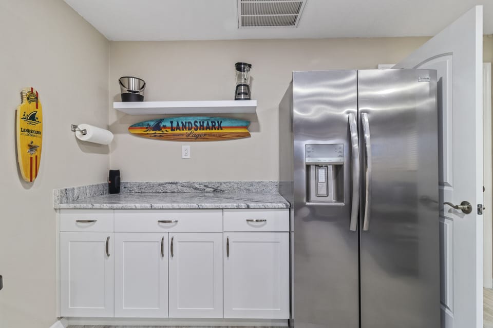 The bonus room has a bar area stocked to enjoy drinks by the pool