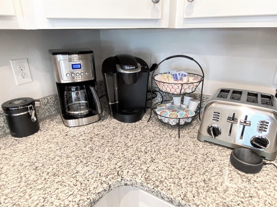 An array of coffee selections and breakfast appliances.