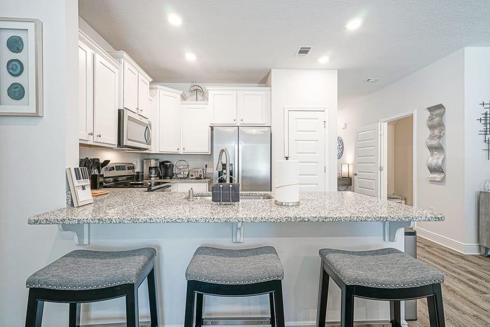 Kitchen counter area with comfortable bar stools.