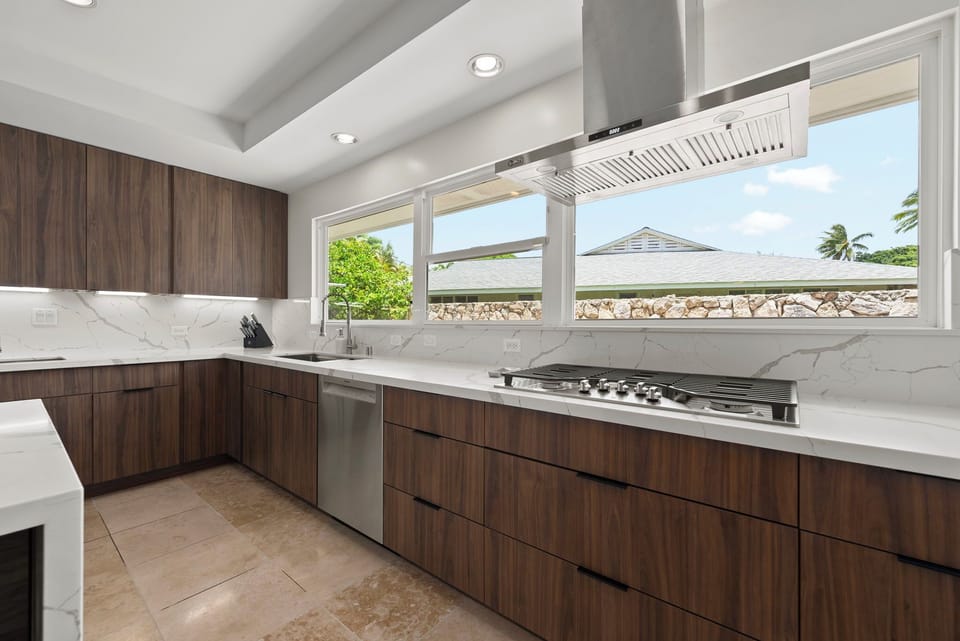 Bright kitchen with expansive counters and large windows that bring in island light.