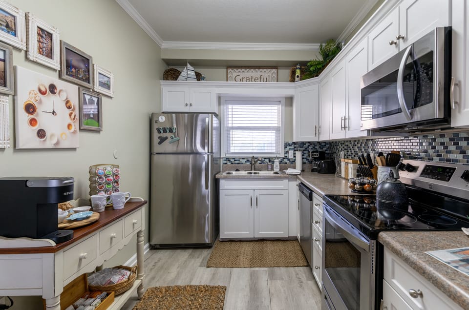 Kitchen is stocked with basics & cooking needs.  Pots & pans, service for 8