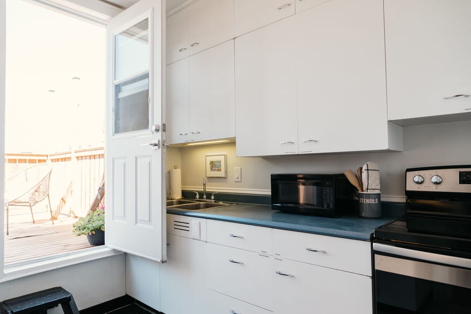 Kitchen is fully stocked with dishes and kitchen tools 