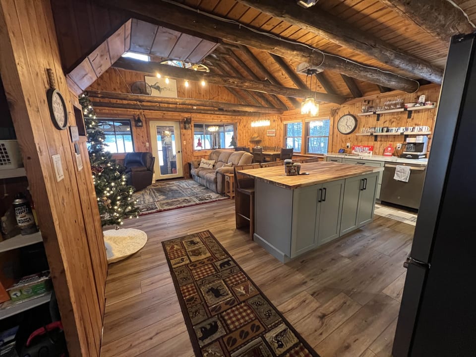 View of kitchen, dining, and main living area from hallway