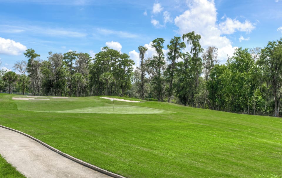 Escape to sweeping fairway views under bright, open skies.