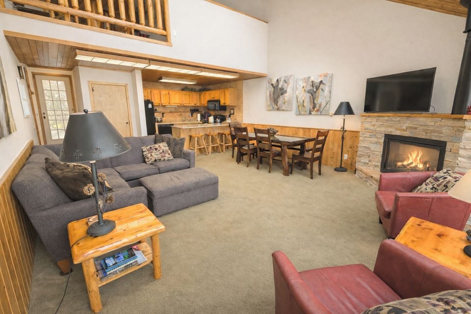Cozy open-plan living with fireplace, loft, and full kitchen