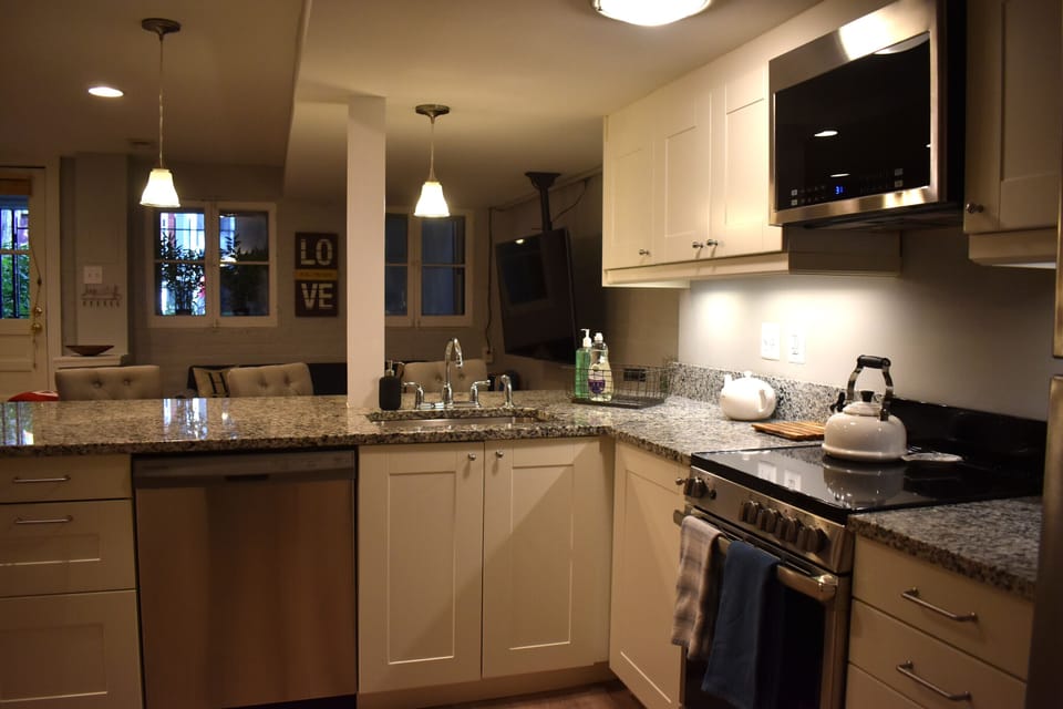 Kitchen area with 3 countertop chairs.