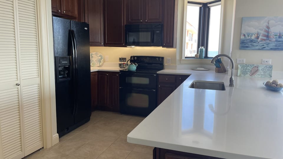 Large kitchen with double ovens and double dishwashers