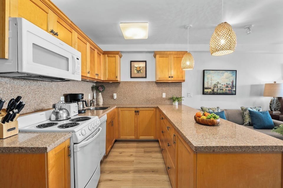 Bright and spacious fully equipped kitchen complete with white appliances