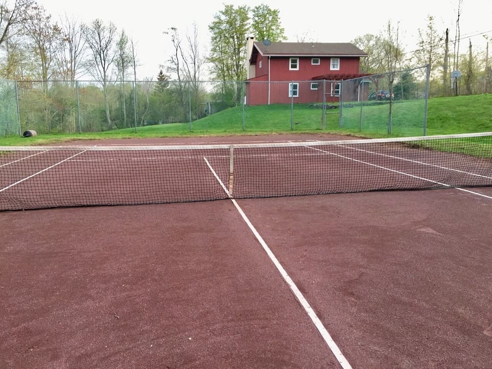 Red clay tennis court opens Memorial Day weekend.
