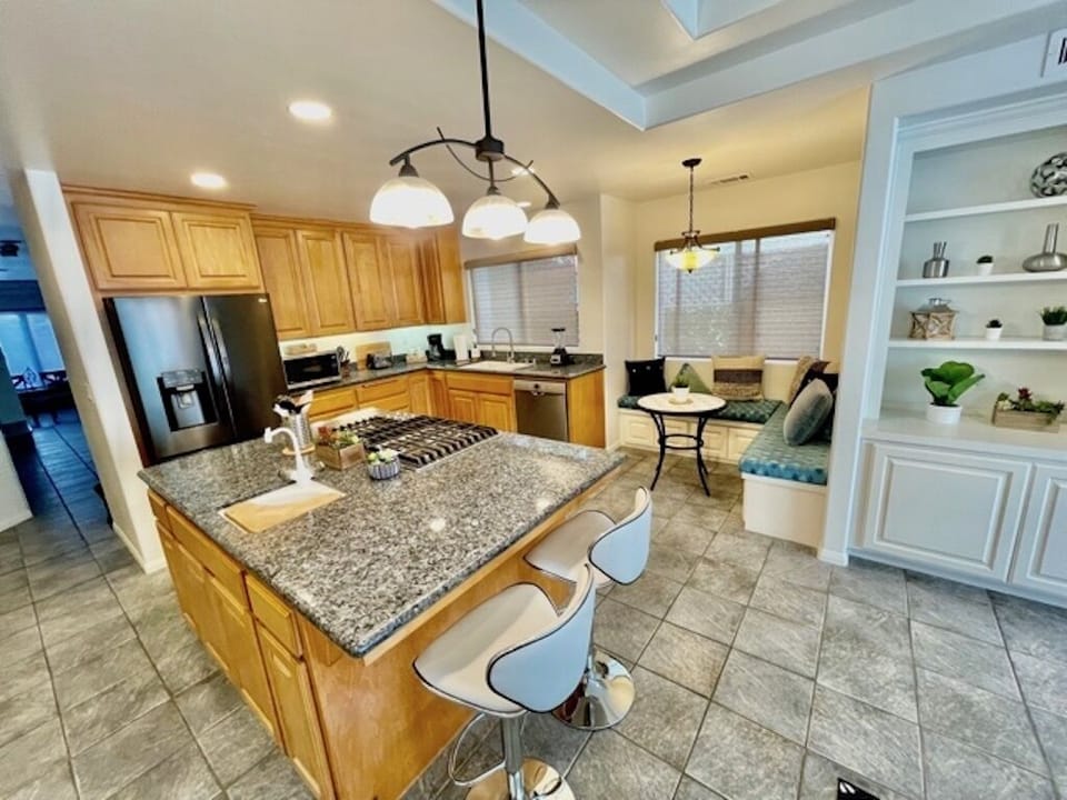 Kitchen with large island and all new luxurious stainless steel appliances. 