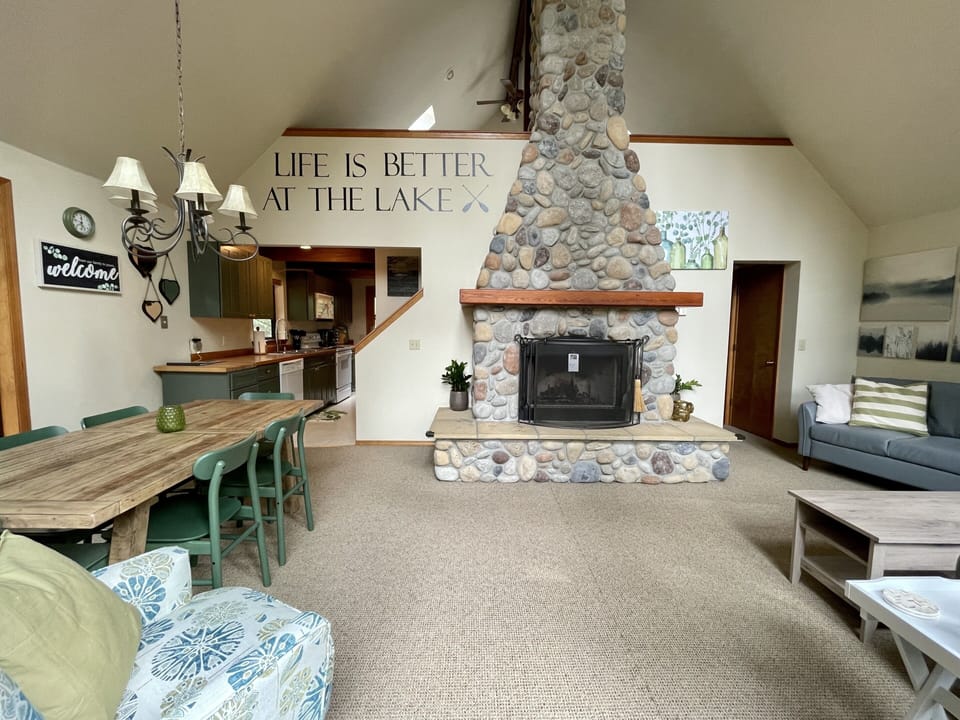 living room, view of loft and river rock fireplace