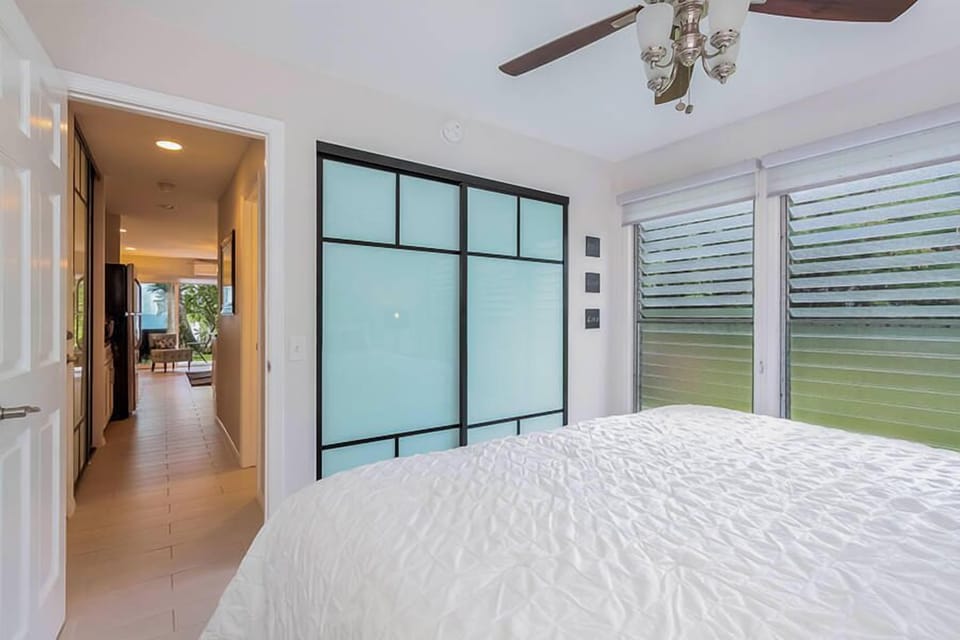 Bedroom looking down the hall to the living area at Kona Isle D1