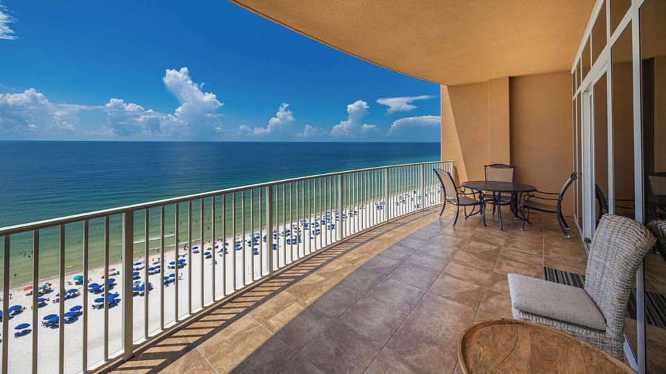 Enjoy meals or drinks on the balcony while taking in sweeping views of the tranquil shoreline and beach below