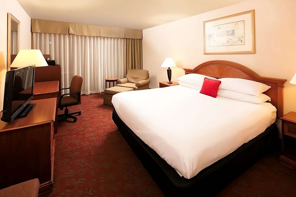 Unwind on crisp linens after a productive day at the desk.