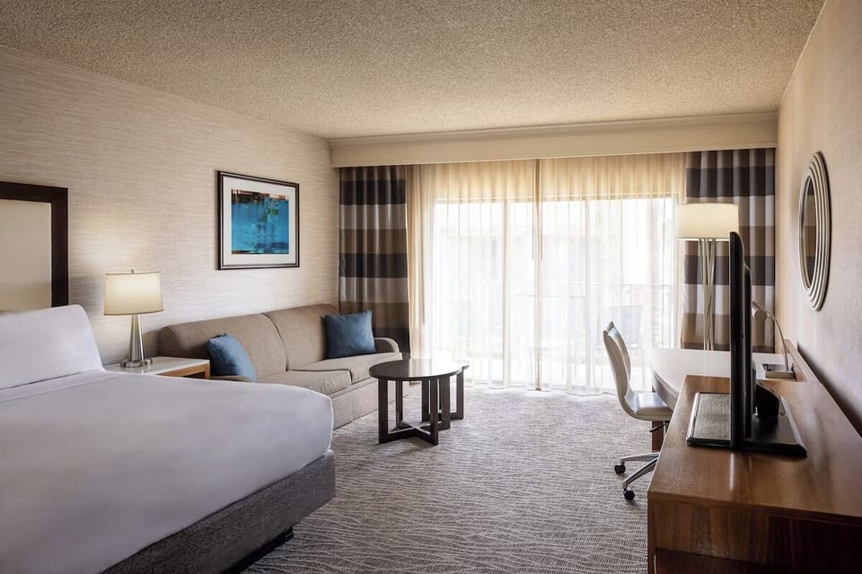 Stretch out with sofa seating and bright balcony doors.