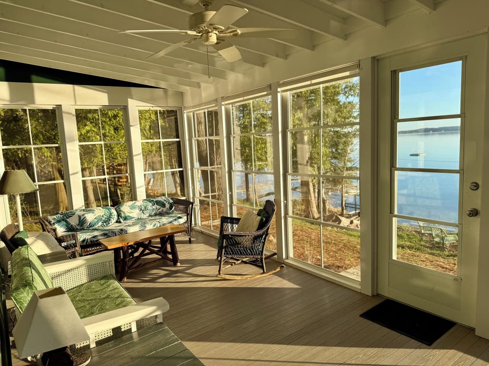 Screened porch overlooking the lake — everyone’s favorite place to gather.