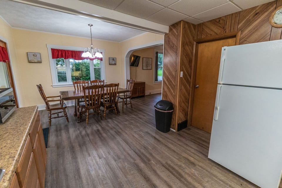 Spacious dining area with essential amenities, including a refrigerator and oven.