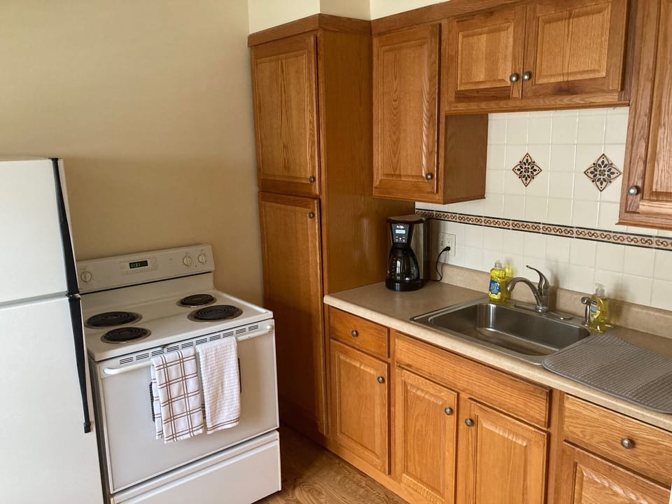 Kitchen with full size range, coffee maker and microwave.
