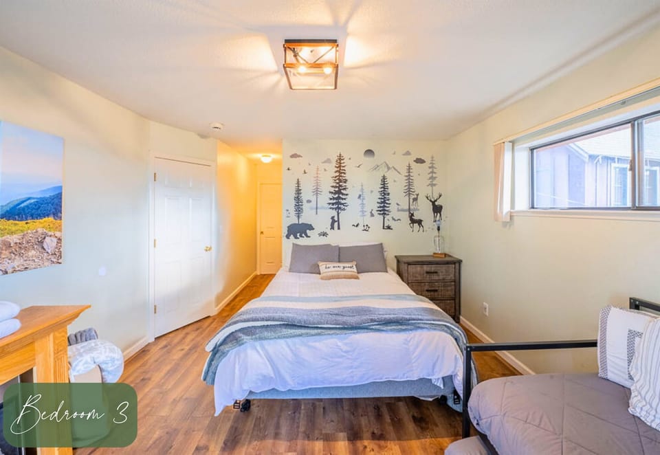 A charming bedroom adorned with forest-inspired art, providing a serene escape in a nature-themed cabin.